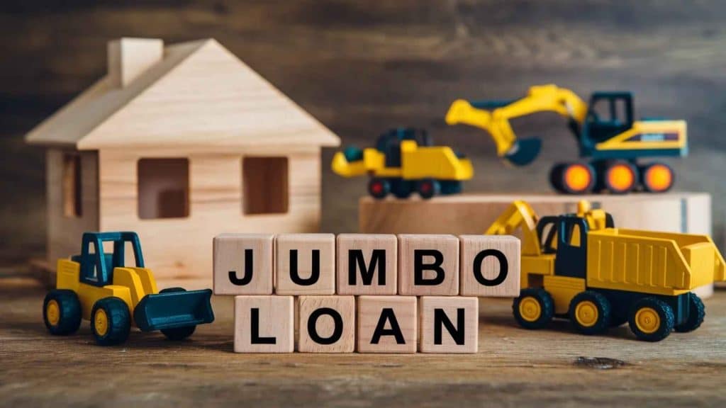 A wooden toy house and construction vehicles with the words Jumbo Loan spelled out in blocks.