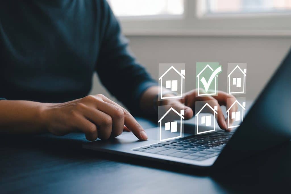 person using a laptop to check home remortgage options for equity release.