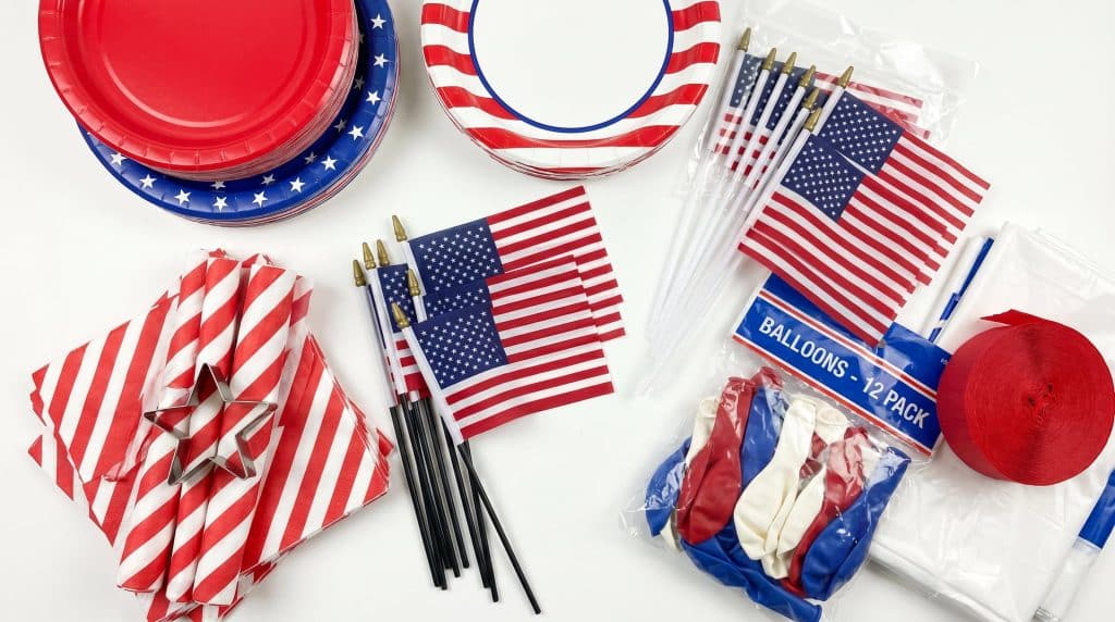 Red and blue plates, napkins, and mini flags for a Memorial Day celebration.