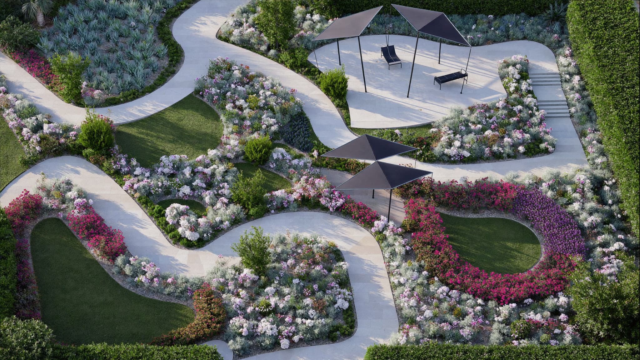 Aerial view of a landscaped garden with winding paths, colorful flower beds, and modern seating areas.