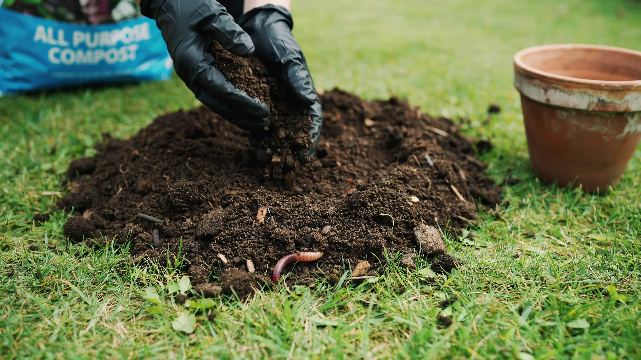 A person mixing soil and compost to grow wild garlic