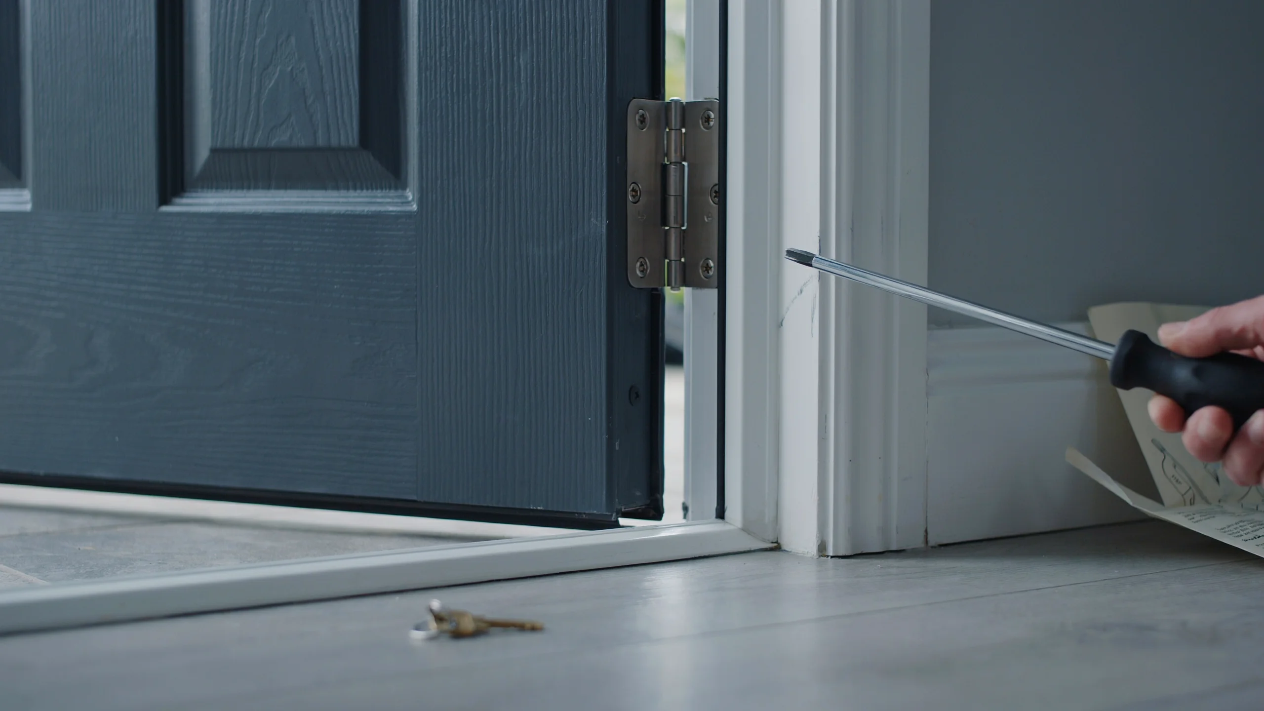 Composite door hinge showing signs of misalignment and adjustment issues.
