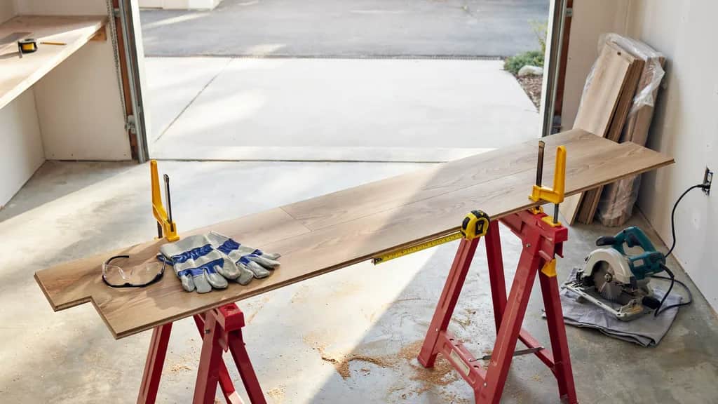 Setting up a stable workspace with laminate flooring boards and cutting tools